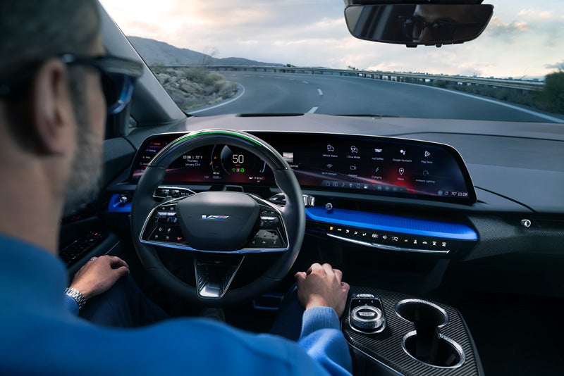 Front View of the 2026 OPTIQ-V Driving Through the Dusk Utilizing its Headlights | Swickard Cadillac of Thousand Oaks in Thousand Oaks CA