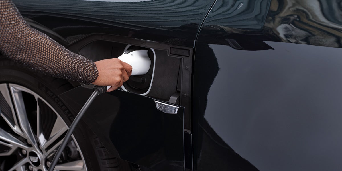 close-up-of-woman-charging-electric-suv-Cadillac-LYRIQ